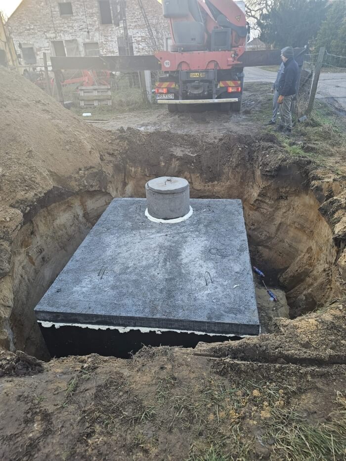 Montáž tesnej betónovej žumpy pomocou žeriavu HDS. Realizácia pre klienta z Tisovec